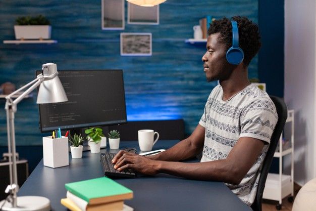 Free Photo _ African american it employee with headset working remote from home